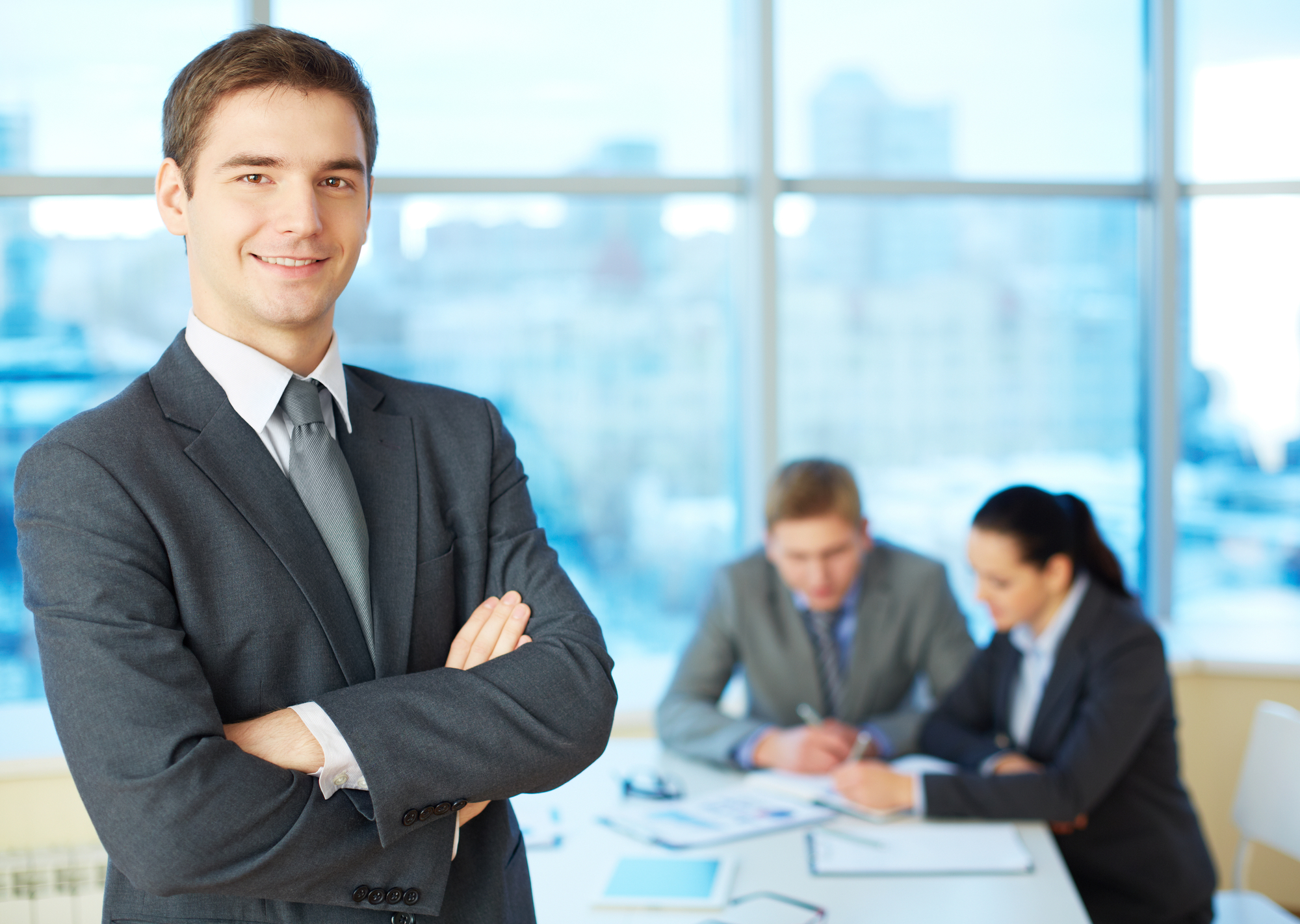 Handsome leader Image of cross-armed leader looking at camera in working environment
